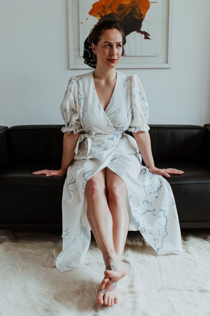 Model wearing long white printed wrap dress from Birdsong