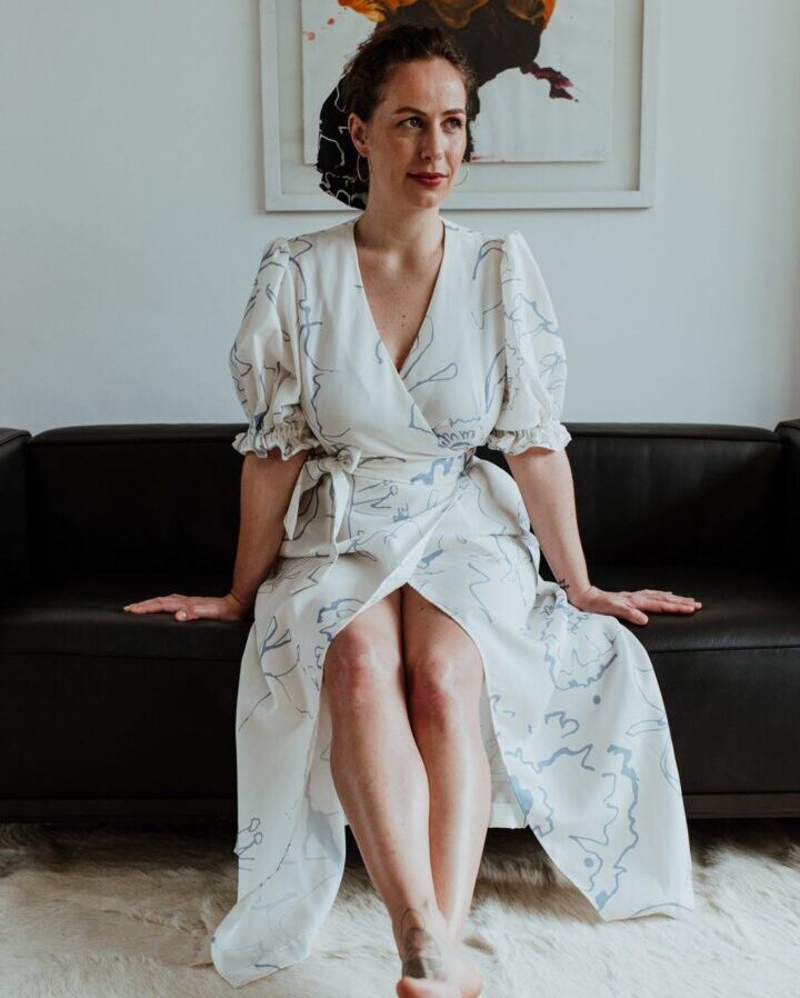 Model wearing long white printed wrap dress from Birdsong