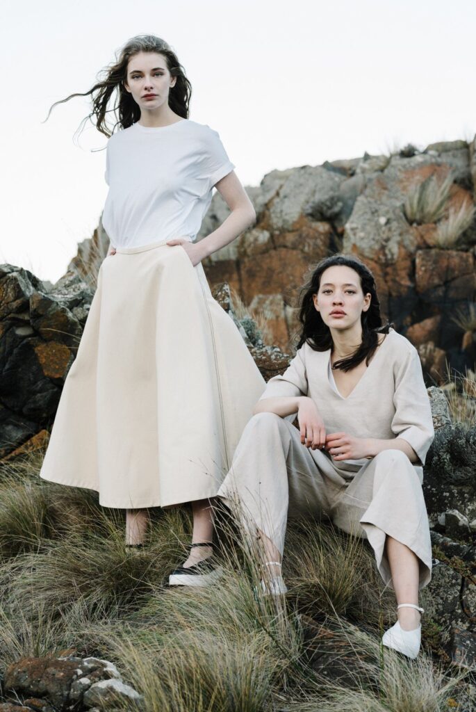 Two models wearing white T-shirt, beige skirt and off-white top with off-white loose pants from ELK