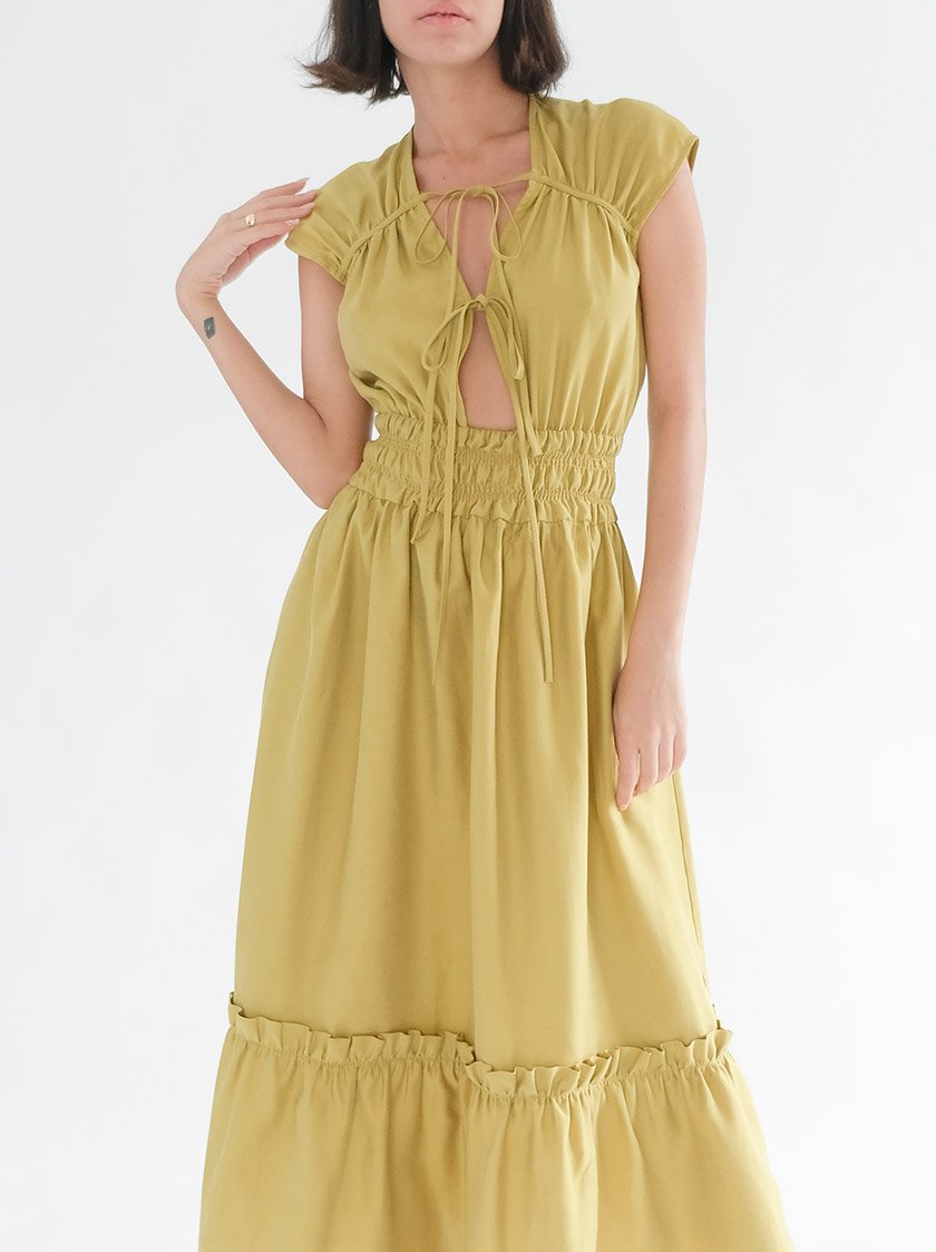 Model wearing a yellow long dress from Noumenon