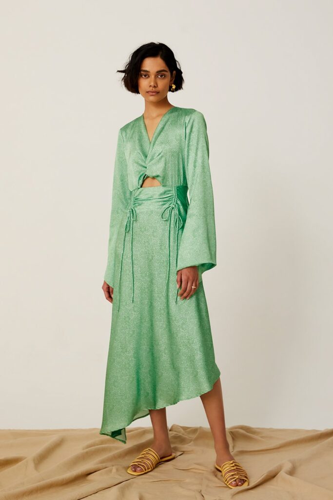 Model wearing a long green dress with long sleeves from Yasmina Q