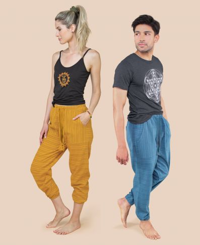 A female model wearing yellow pants and a tank top with print, and a male model wearing blue pants with a graphic T-shirt from sustainable brand Soul Flower