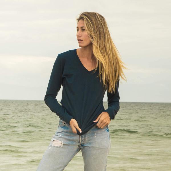 Model wearing a dark blue long sleeve V-neck T-shirt from sustainable brand The Classic T-Shirt Company