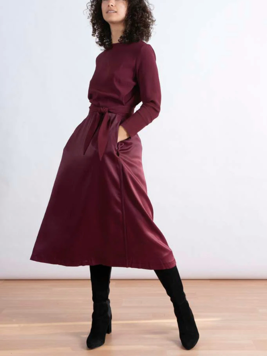 Model wearing a burgundy midi dress from sustainable brand Nina Rein