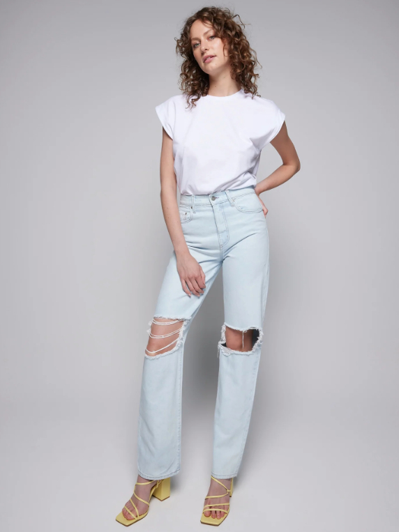 Model wearing light blue straight leg ripped jeans with a white T-shirt from Nobody Denim