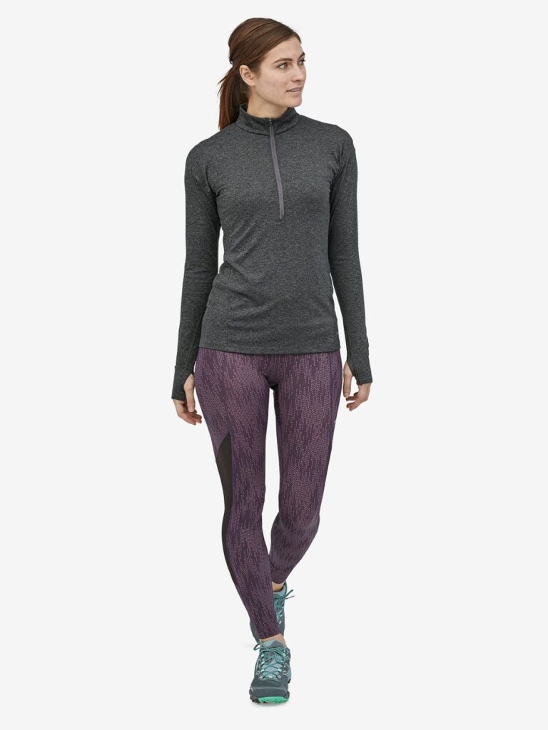 Model wearing purple leggings with a dark grey thermo top from Patagonia 