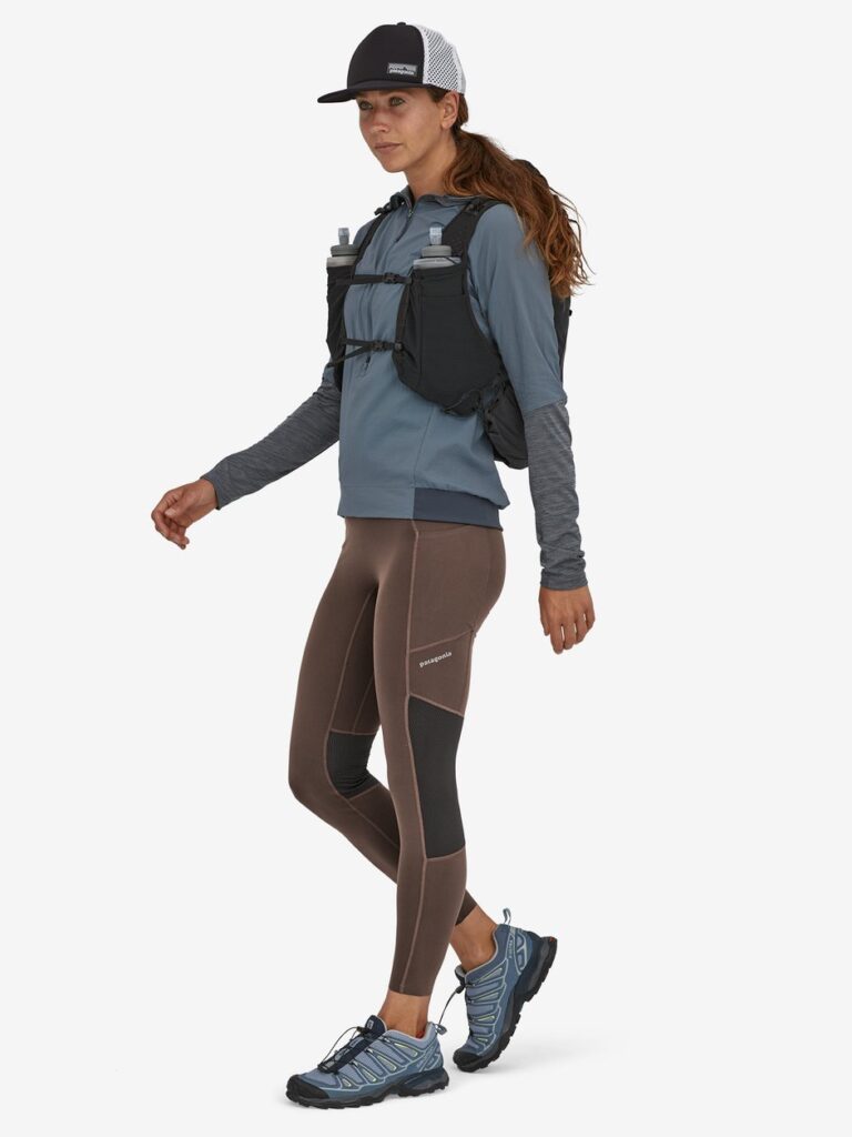 Model wearing brown leggings with a blue thermo top from sustainable brand Patagonia