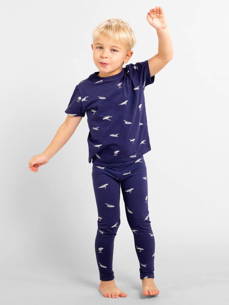 Kid wearing dark blue printed leggings and a matching T-shirt from Dedicated