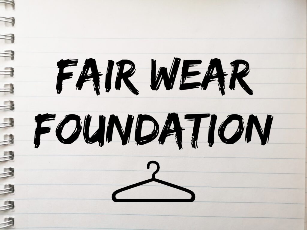 Thumbnail for article about Fair Wear Foundation. Lined paper with text: 'Fair Wear Foundation' and a drawing of a clothing hanger