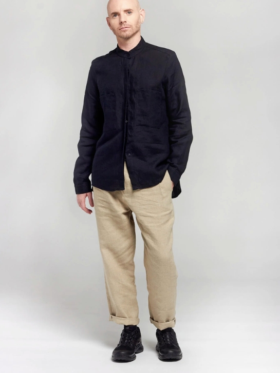 Male model wearing a black shirt and beige pants from A.BCH with black shoes