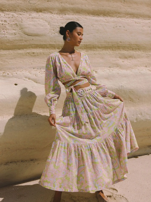 Model wearing a pastel coloured maxi skirt and a matching long sleeve crop top from sustainable brand Arnhem
