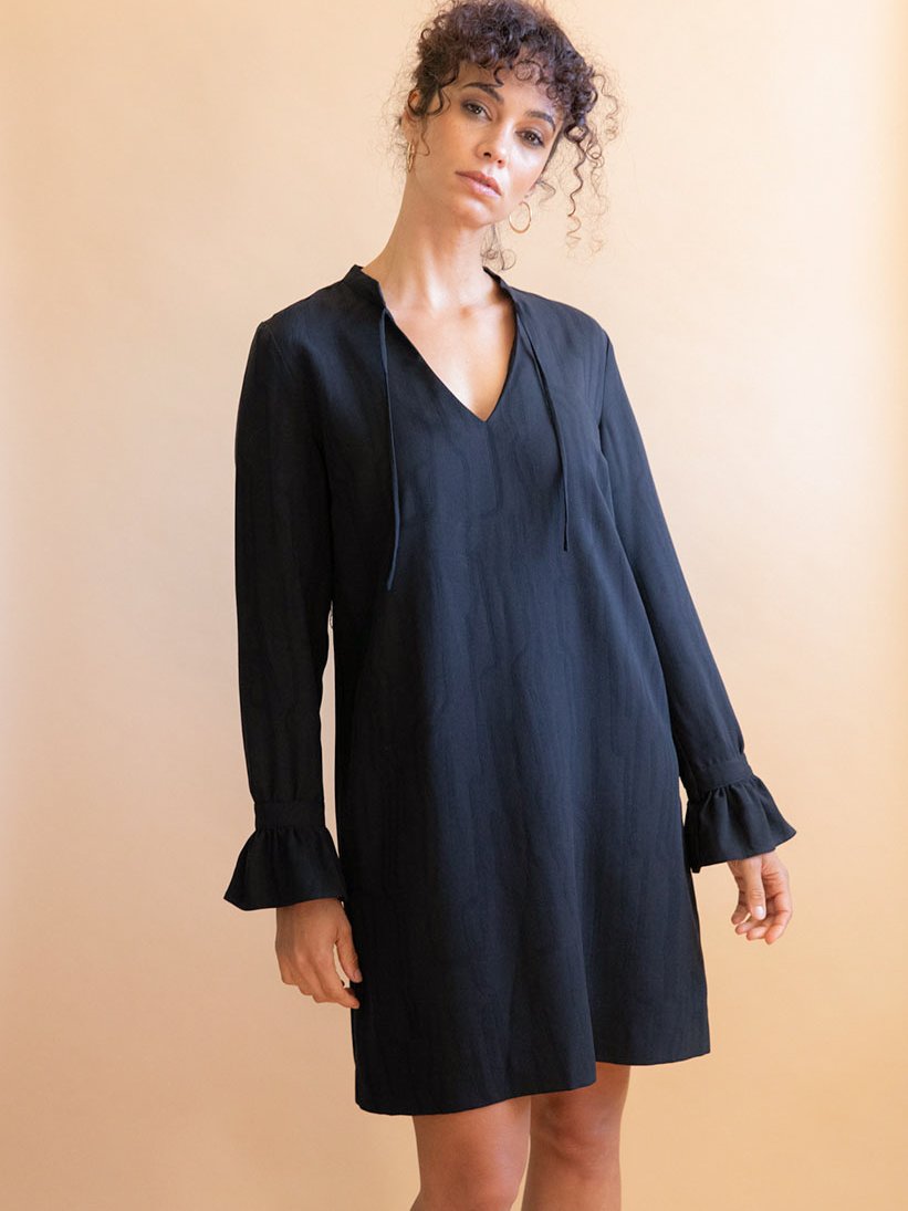 Model wearing a dark blue short dress from sustainable brand Avani