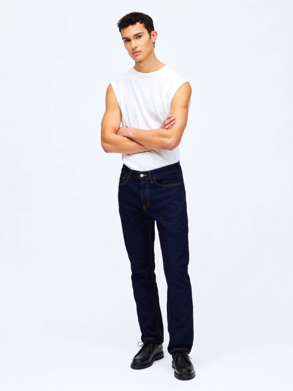 Male model wearing dark blue jeans from sustainable brand HNST