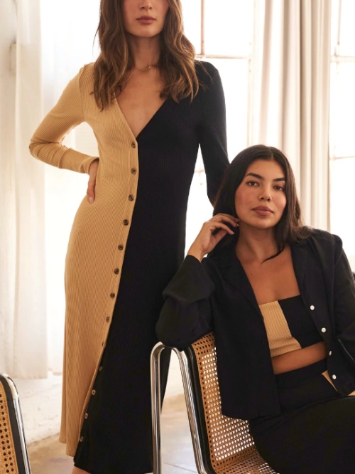 Two models wearing a black and beige two-tone dress and a tube top, and a black jacket from sustainable brand Whimsy + Row for their Black Friday 2023 sale