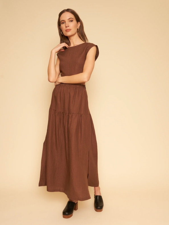 Model wearing a brown maxi dress from sustainable brand Whimsy + Row